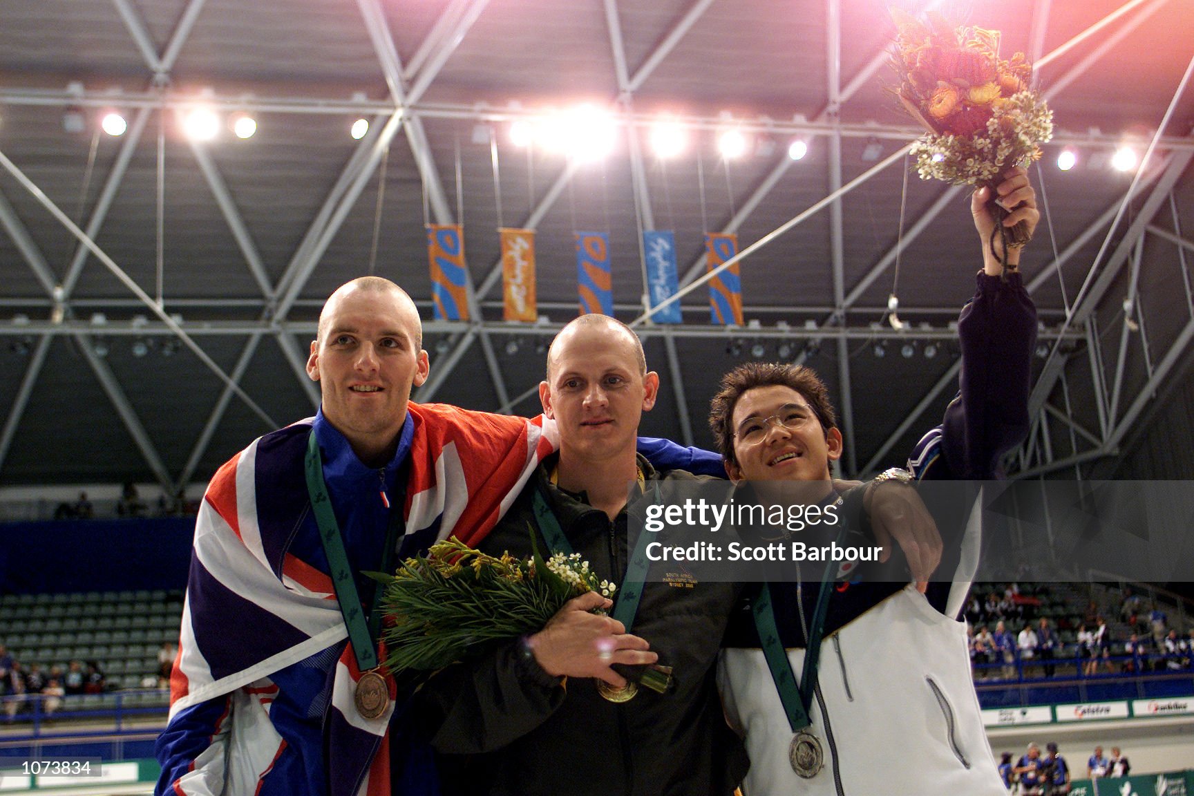 24 Oct 2000:   Darren Leach (bronze)of Great Britain, Ebert Kleynhans (gold)of South Africa and Yoshikazu Sakai (silver) of Japan during the medal presentation  for the Mens 100M Freestyle S12 Final held at Olympic Park during the Sydney 2000 ParalympicGames, Sydney, Australia. DIGITAL IMAGE. Mandatory Credit: Scott Barbour/ALLSPORT